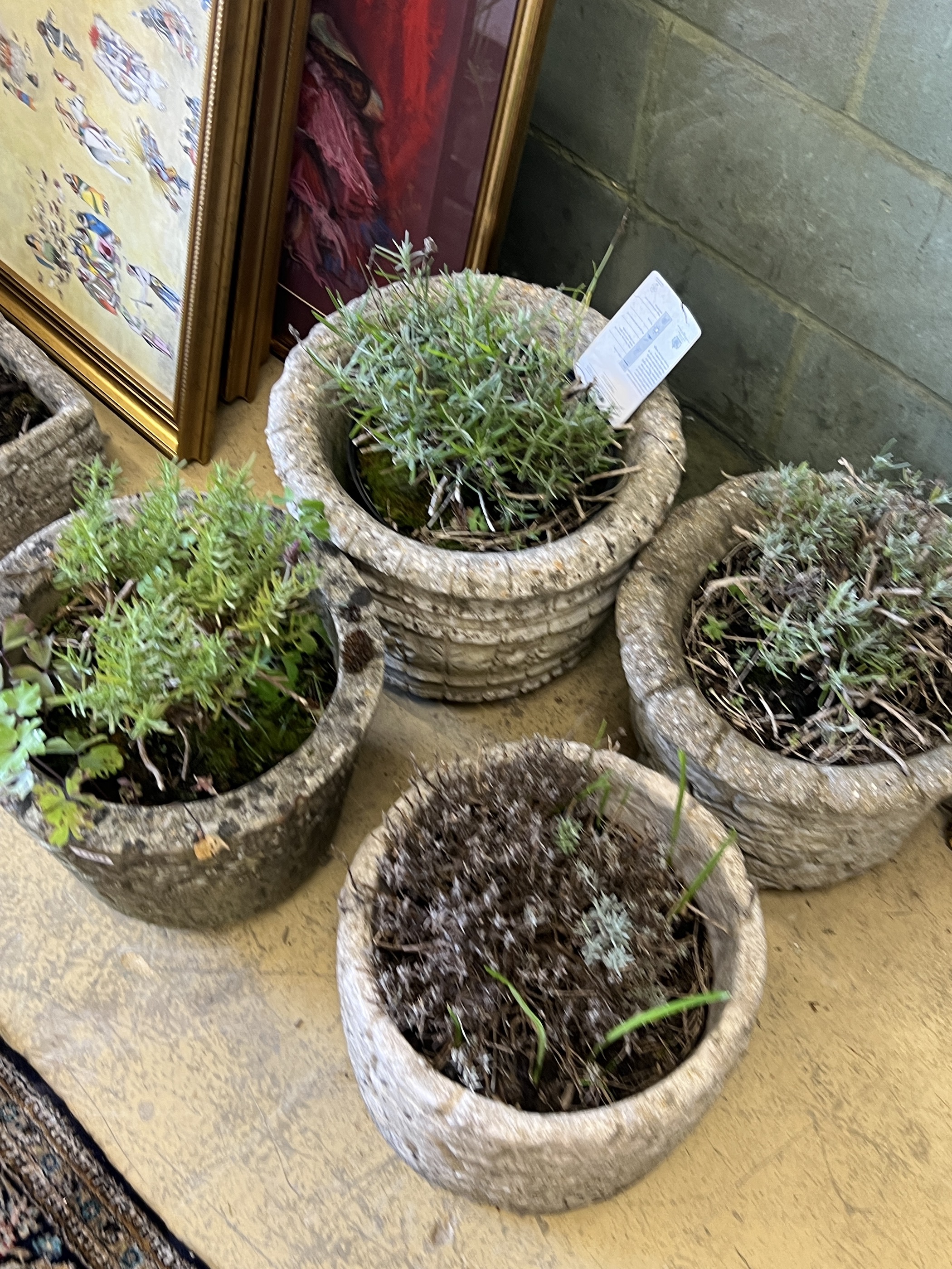 Four circular reconstituted stone garden planters, largest diameter 38cm, height 30cm